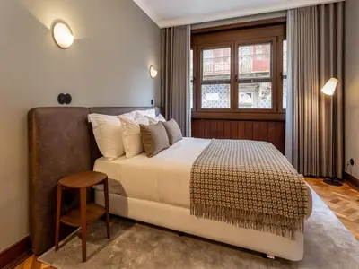 a bedroom with a large bed and a window at Spacious family apartment in Porto in Porto