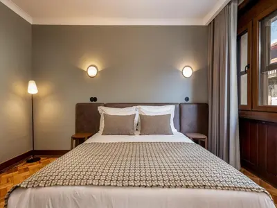 a bedroom with a large bed with two pillows at Spacious family apartment in Porto in Porto