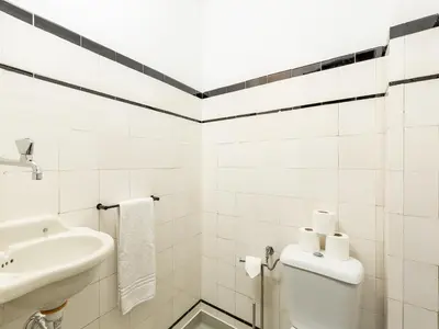 a white bathroom with a sink and a toilet at Spacious family apartment in Porto in Porto