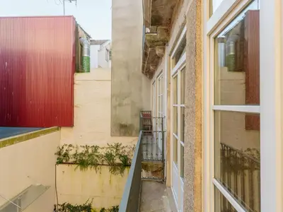an alleyway between two buildings with a window at Cozy Getaway in Porto with Balcony in Porto