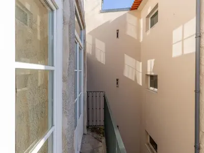 a corridor of a building with a window at Cozy Getaway in Porto with Balcony in Porto