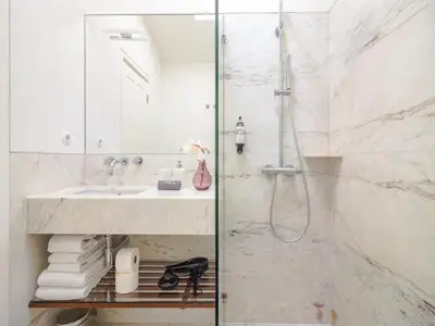 a bathroom with a sink and a shower at City-center apartment with modern comforts in Porto