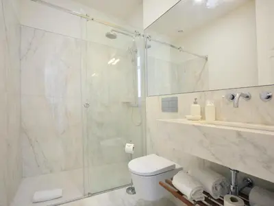 a bathroom with a glass shower and a toilet at Charming City-Center Studio in Porto in Porto