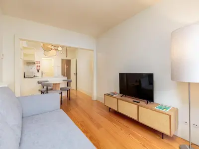 a living room with a couch and a television at Apartment in Porto with balcony in Porto