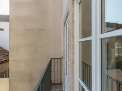 a balcony of a building with a window at Apartment in Porto with balcony in Porto
