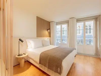 a bedroom with a bed and a large window at Apartment in Porto with balcony in Porto