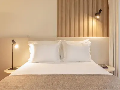 a bedroom with a bed with white pillows at Apartment in Porto with balcony in Porto