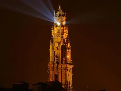 a clock tower at night with a light on it at Porto Retreat Comfort & Style in the Heart in Porto