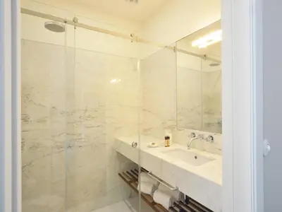 a bathroom with a sink and a shower at Porto Retreat Comfort & Style in the Heart in Porto