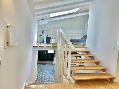 a staircase in a room with white walls and wooden floors at Charming 2-Bedroom Apartment in Porto in Porto