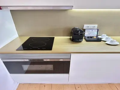 a kitchen with a counter with a stove and a phone at Heart of Porto Cozy Escape in Porto