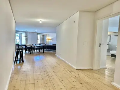 an open living room and dining room with white walls at Heart of Porto Cozy Escape in Porto