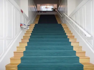 a staircase with blue carpeted stairs in a building at Central City Escape with Balcony in Porto