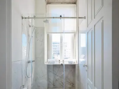 a bathroom with a shower and a window at Central City Escape with Balcony in Porto