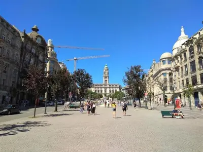 a group of people walking on a street with buildings at Spacious 2-Bedroom Retreat in Porto in Porto