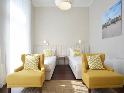 a living room with two yellow chairs and a couch at Cozy and modern apartment in Porto in Porto