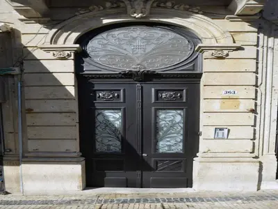 a black door on the side of a building at Cozy and modern apartment in Porto in Porto
