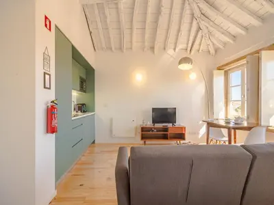 a living room with a couch and a table at Cozy Porto studio perfect location & comfort in Porto