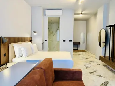 a hotel room with a bed and a couch at Modern apartment in the heart of Porto in Porto