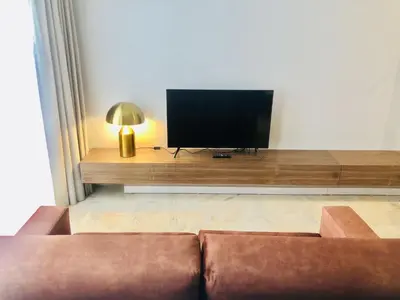 a living room with a couch and a flat screen tv at Charming urban apartment in Porto's heart in Porto