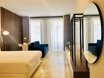 a hotel room with a bed and a mirror at Bright and Spacious apartment in Porto in Porto