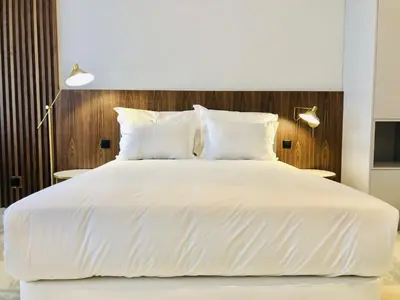 a large white bed with white sheets and pillows at Bright and Spacious apartment in Porto in Porto