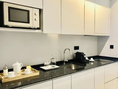 a kitchen with a sink and a microwave at Bright and Spacious apartment in Porto in Porto