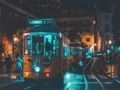 a trolley car on a city street at night at Bright and Spacious apartment in Porto in Porto