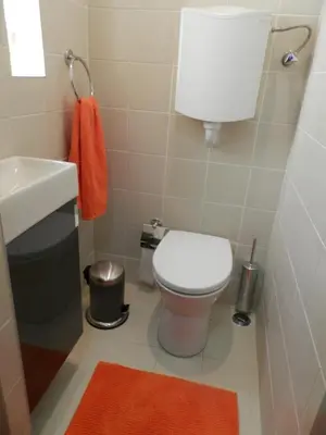 a small bathroom with a toilet and a sink at Charming House Quental in Porto