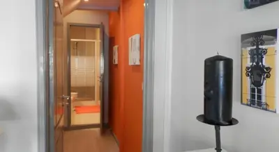 a room with a television on a stand next to a hallway at Charming House Quental in Porto