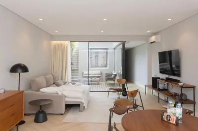 a living room with a white couch and a table at Liiiving in Porto - Pool Paradise Apartments in Porto