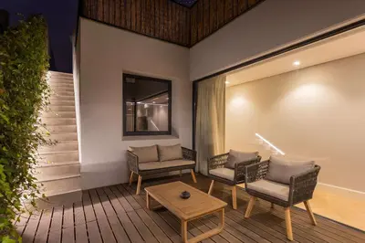 a living room with two chairs and a table at Liiiving in Porto - Pool Paradise Apartments in Porto