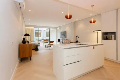a kitchen with a counter and a living room at Liiiving in Porto - Pool Paradise Apartments in Porto