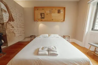a bedroom with a bed with towels on it at Boutique Suites by Hosty in Porto