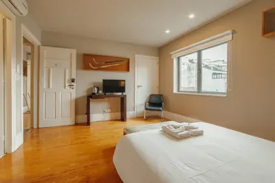 a bedroom with a large white bed and a window at Boutique Suites by Hosty in Porto