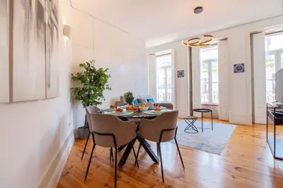 a dining room with a table and chairs at Bright Flat few steps to Aliados Av by LovelyStay in Porto