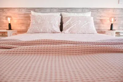 a bedroom with a large white bed with two lamps at Central with balcony - 9 min-walk to Trindade in Porto
