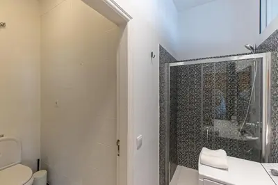 a bathroom with a shower and a toilet at Oporto Spacious apartment in Porto