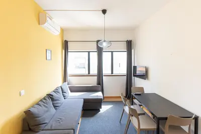 a living room with a couch and a table at Oporto Spacious apartment in Porto
