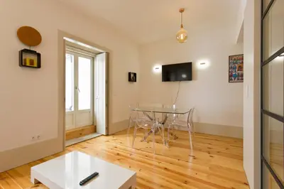 a dining room with a glass table and a window at Aposentus - Premium Central Apartment 1BR in Porto