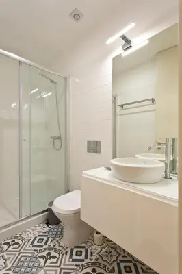 a bathroom with a sink and a toilet and a shower at Aposentus - Premium Central Apartment 1BR in Porto