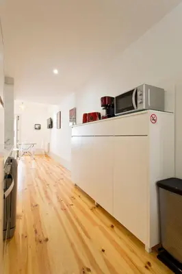 a kitchen with a counter with a microwave on it at Aposentus - Premium Central Apartment 1BR in Porto