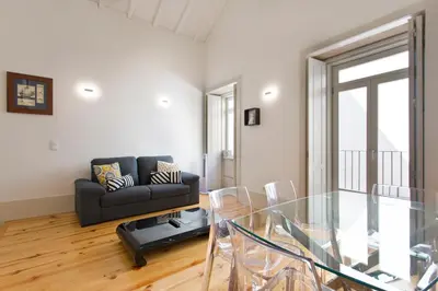 a living room with a glass table and a couch at Aposentus - Premium Central Apartment 3BR in Porto