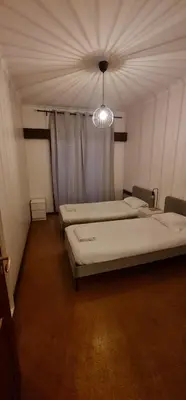 a room with three beds and a chandelier at Catarina 711 in Porto