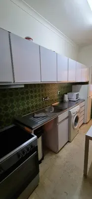 a kitchen with a stove and a sink and a dishwasher at Catarina 711 in Porto