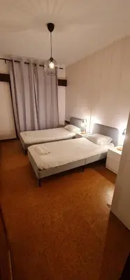 a bedroom with two beds and a chandelier at Catarina 711 in Porto