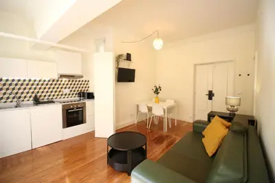 a kitchen and a living room with a table at MyStay - The Poet - Fernando Pessoa in Porto