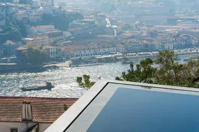 a view of a river with a boat in the water at GuestReady - D. Hugo Boutique Hotel B&B in Porto