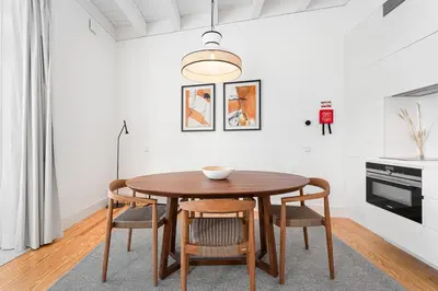 a dining room with a wooden table and chairs at GuestReady - D. Hugo Boutique Hotel B&B in Porto