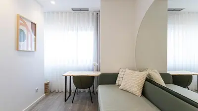 a living room with a couch and a table at Bright 2BR Flat near Praça da Galiza by LovelyStay in Porto
